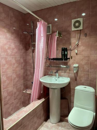 a bathroom with a sink and a toilet and a shower at Mtskheta Apartment 158 in Mtskheta