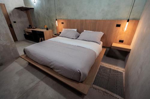 a bedroom with a large bed with a wooden headboard at Casa 1800 Oaxaca Boutique Hotel City Center based in Oaxaca City