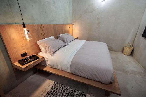 a bedroom with a large bed with a wooden frame at Casa 1800 Oaxaca Boutique Hotel City Center based in Oaxaca City