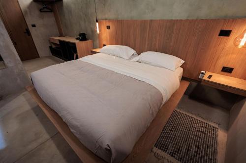 a bedroom with a large bed with a wooden wall at Casa 1800 Oaxaca Boutique Hotel City Center based in Oaxaca City
