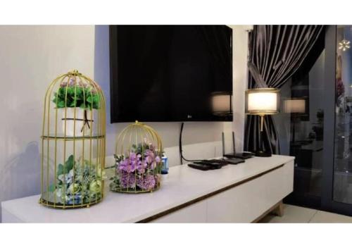 a room with two bird cages with flowers on a counter at ROMANCE FULL HOUSE THREE PREMIER SUITE in Butterworth