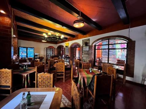 a dining room with tables and chairs in a restaurant at Hotel Boutique Posada la Casona de Cortés in Tlaxcala de Xicohténcatl