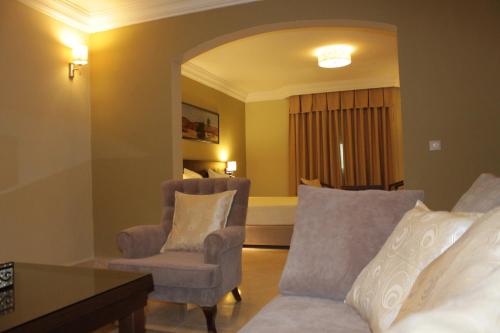 a living room with a couch and a chair at Hotel Mauricenter Nouakchott in Nouakchott