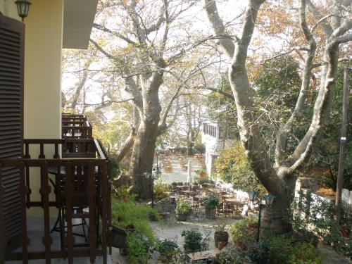 a view of a garden from the balcony of a house at Pelias Hotel in Portariá