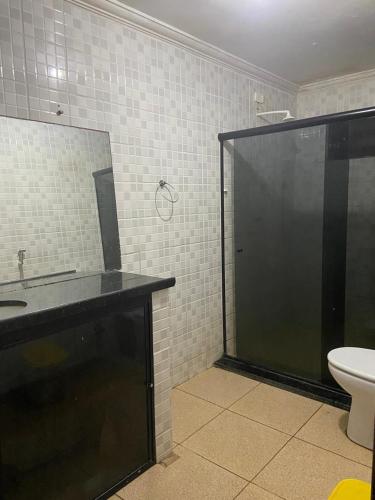 a bathroom with a shower and a sink and a toilet at casa ilha de itamaraca in Itamaracá