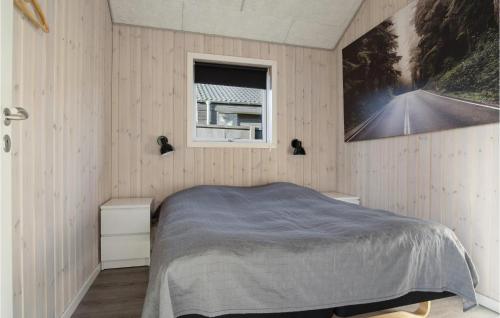 a bedroom with a bed and a window at Lovely Home In Sjølund in Sjølund