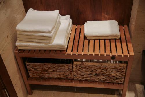 two stacks of towels sitting on a wooden shelf at Apartament Erica in Zakopane