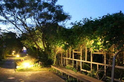 a park bench with lights on it at night at Maple in Wujie