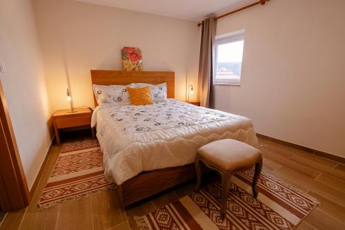 a bedroom with a large bed and a window at Casa da Adega in Vila Real