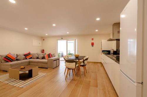 a kitchen and living room with a couch and a table at Casa da Adega in Vila Real