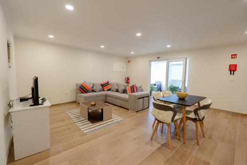 a living room with a couch and a table at Casa da Adega in Vila Real