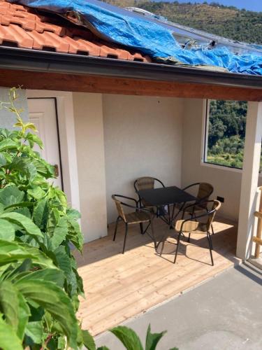 a patio with a table and chairs on a roof at Casa Matilde in Sanremo