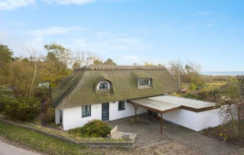 a house with a thatched roof with a porch at 4 Bedroom Stunning Home In Humble in Humble