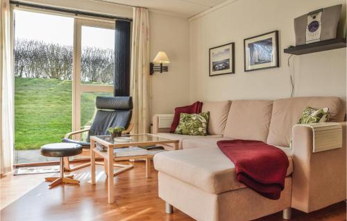 a living room with a couch and a table at 2 Bedroom Lovely Apartment In Lemvig in Lemvig