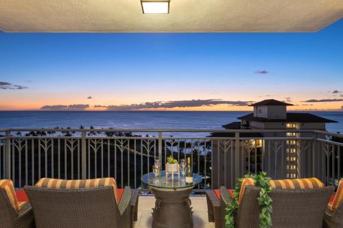 a balcony with a table and chairs and the ocean at Ko Olina Beach Villas O1404 in Kapolei