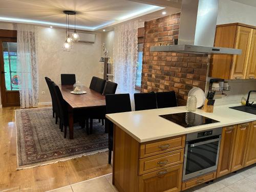 a kitchen and dining room with a table and chairs at ANDRIJIN stan in Cerić