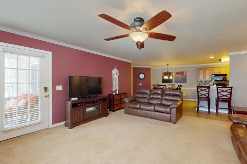 a living room with a couch and a ceiling fan at Sterling Pointe 120-A at Wachesaw III in Myrtle Beach