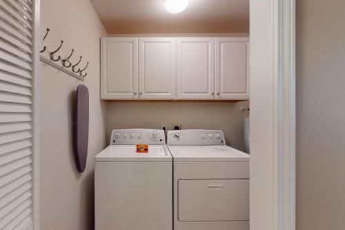 a white laundry room with a washer and dryer at Sterling Pointe 120-A at Wachesaw III in Myrtle Beach