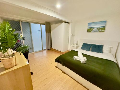 a bedroom with a large bed with a white object on it at Prime 1BR Near Transport and Retail in Brisbane