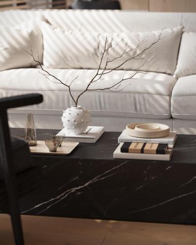 a black coffee table with a white cake on top of it at The March Hotel in Miami Beach