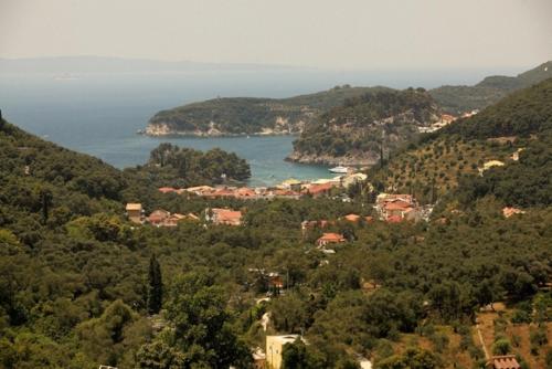 a view of a town on a hill with the ocean at Salvator Villas & Spa Hotel in Parga