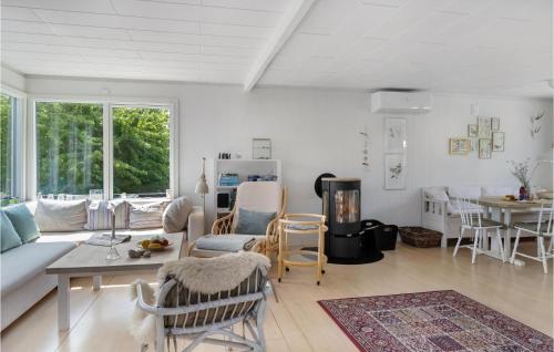 a living room with a couch and a table and chairs at Awesome Home In Nykøbing Sj With Wifi in Nyrup