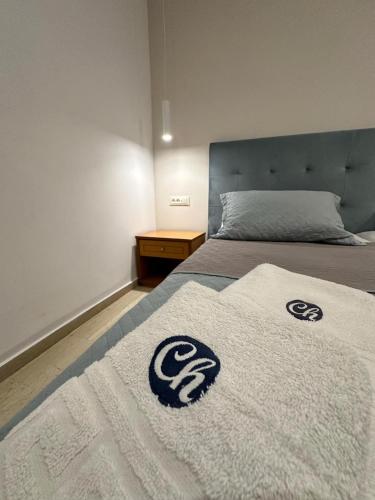 a bed with a white blanket on top of it at Castro Hotel in Amoudara Herakliou