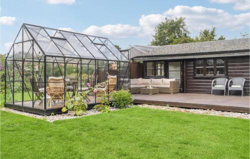 a greenhouse in the backyard of a house at Amazing Home In Stege With Kitchen in Stege