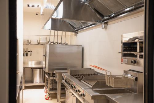 a large commercial kitchen with a stove top oven at Hotel Boutique Gualamba in General Pinedo