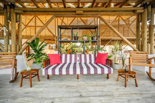 a living room with a striped couch and chairs at Spacious Bright & Airy Penthouse C at Playa Venao in Playa Venao