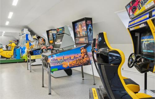 a row of video game machines in a store at 2 Bedroom Amazing Apartment In Rømø in Sønderby