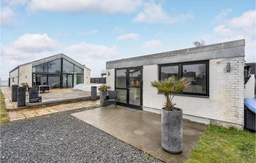 a white brick house with large glass windows at 4 Bedroom Amazing Home In Strøby in Strøby