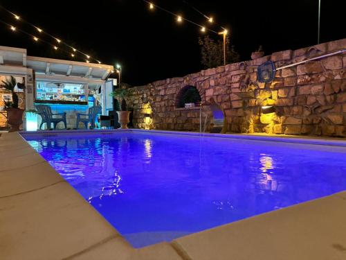 a swimming pool at night with blue lighting at Villa Irma guest house in Crotone