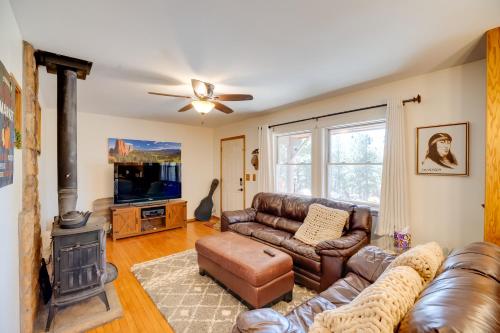 a living room with leather furniture and a fireplace at Fish, Hike and Sightsee Lovely Florissant Cabin! in Florissant