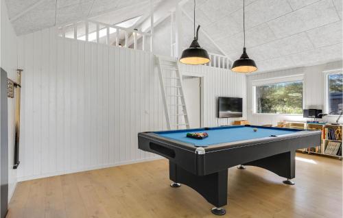 a pool table in the middle of a room at Lovely Home In Blokhus With Sauna in Blokhus