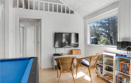 a living room with a pool table and a tv at Lovely Home In Blokhus With Sauna in Blokhus