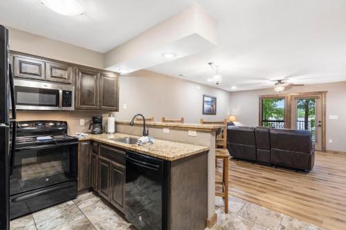 a kitchen with wooden cabinets and a counter top at Table Rock Resorts at Indian Point in Branson