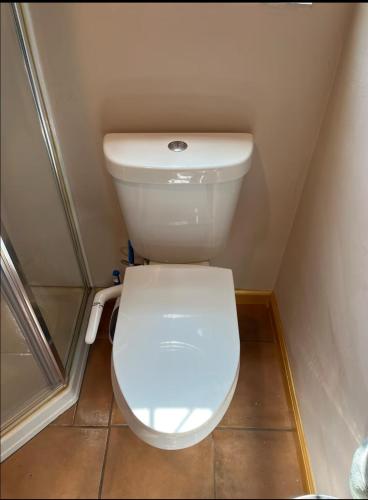 a bathroom with a white toilet in a small room at Charming Casita all too yourself near Midtown, Train and Freeway in Sacramento