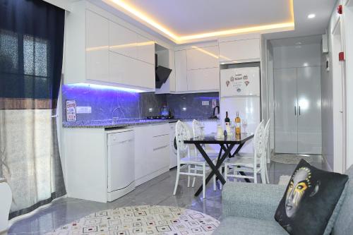 a kitchen with a table and a dining room at PRETTY HOUSE in Pamukkale