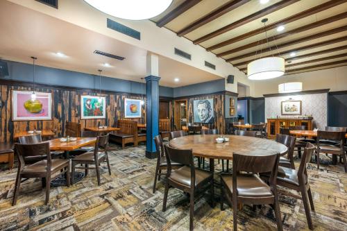 a dining room with wooden tables and chairs at Best Western Premier Mariemont Inn in Cincinnati