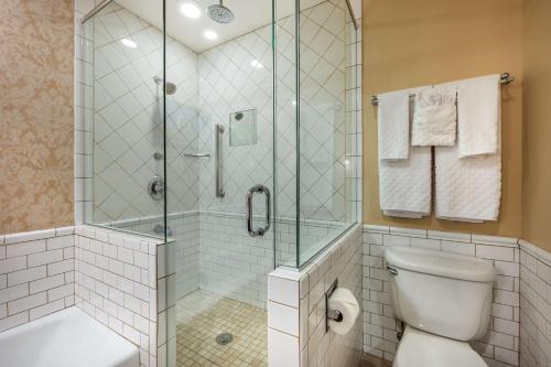 a bathroom with a shower and a toilet at Best Western Premier Mariemont Inn in Cincinnati