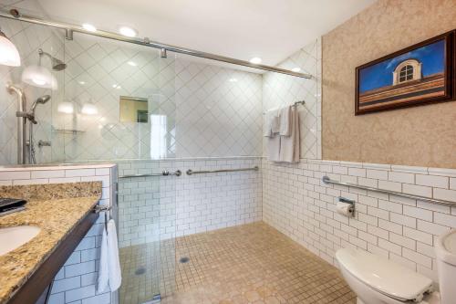a bathroom with a toilet and a sink and a mirror at Best Western Premier Mariemont Inn in Cincinnati