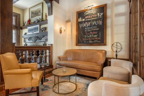 a living room with furniture and a chalkboard on the wall at Best Western Premier Mariemont Inn in Cincinnati