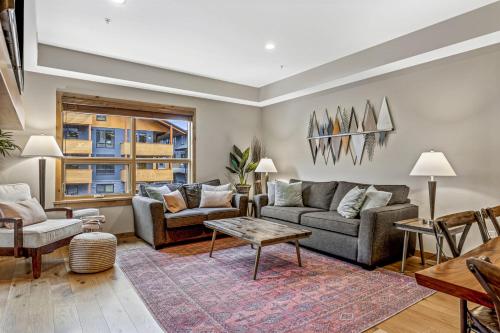a living room with two couches and a table at Alpine Serenity in Canmore in Canmore