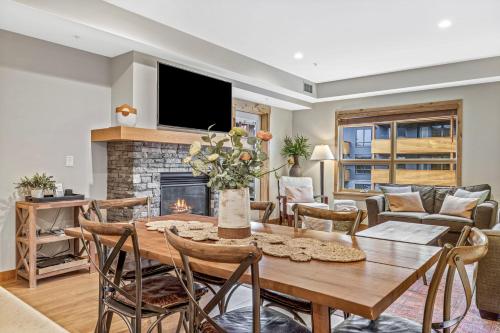 a dining room with a table and a fireplace at Alpine Serenity in Canmore in Canmore