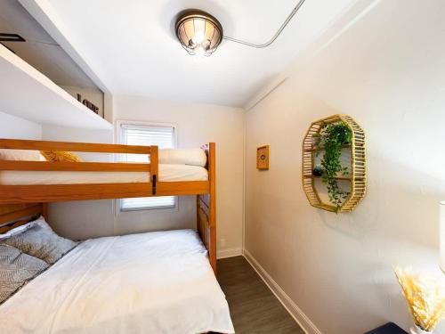 a bedroom with two bunk beds and a mirror at Chi-Town Hideout #1 - Near Metra in Berwyn