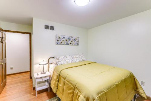 a bedroom with a bed with a yellow bedspread at On-Site Lake and Gazebo Cabin in Yellow Springs! in Fairborn