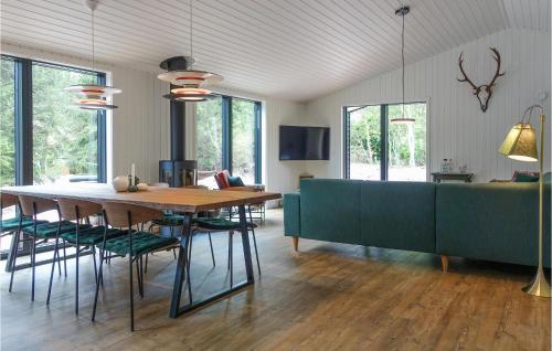 a dining room and living room with a table and chairs at Lovely Home In Nexø With Kitchen in Neksø