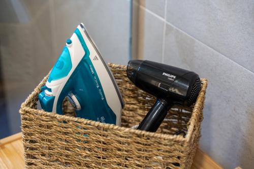 a basket with a toothbrush and a hair dryer at Apartman Filipović, Vila Dunav in Zlatibor
