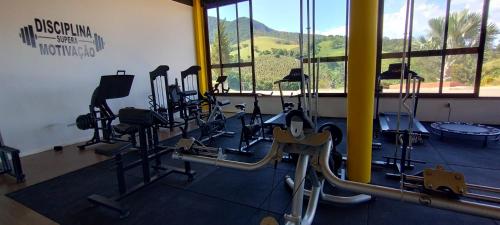 a gym with a bunch of exercise bikes in a room at Hotel Chalés Capitanias in Águas de Lindóia